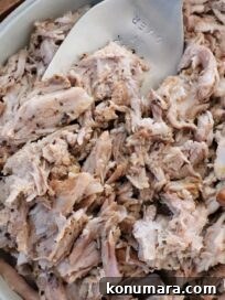 Slow-Cooker BBQ Pulled Pork Recipe 15 pulled pork in bowl with serving fork