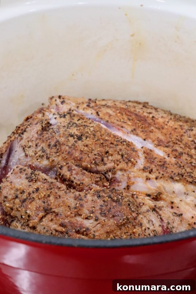Slow-Cooker BBQ Pulled Pork Recipe 5 seasoned pork shoulder in a cast iron dutch oven