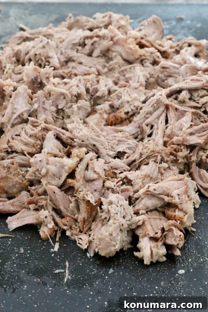 Slow-Cooker BBQ Pulled Pork Recipe 6 shredded pulled pork on a cutting board