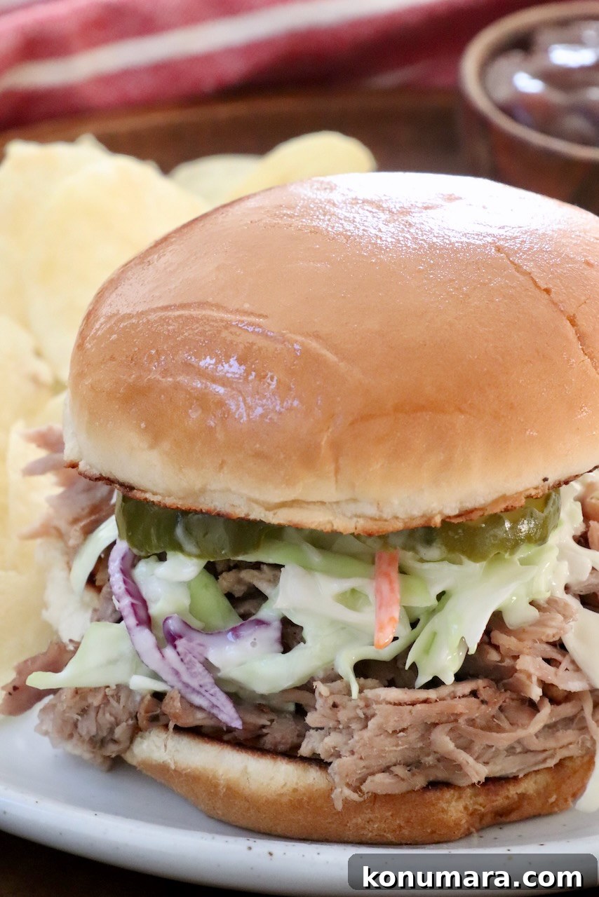 Slow-Cooker BBQ Pulled Pork Recipe 7 pulled pork sandwich on a plate topped with coleslaw