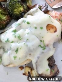 Pan Seared Chicken with Mushrooms and Swiss Cheese 13 chicken covered in mushrooms and cheese on a plate with broccoli