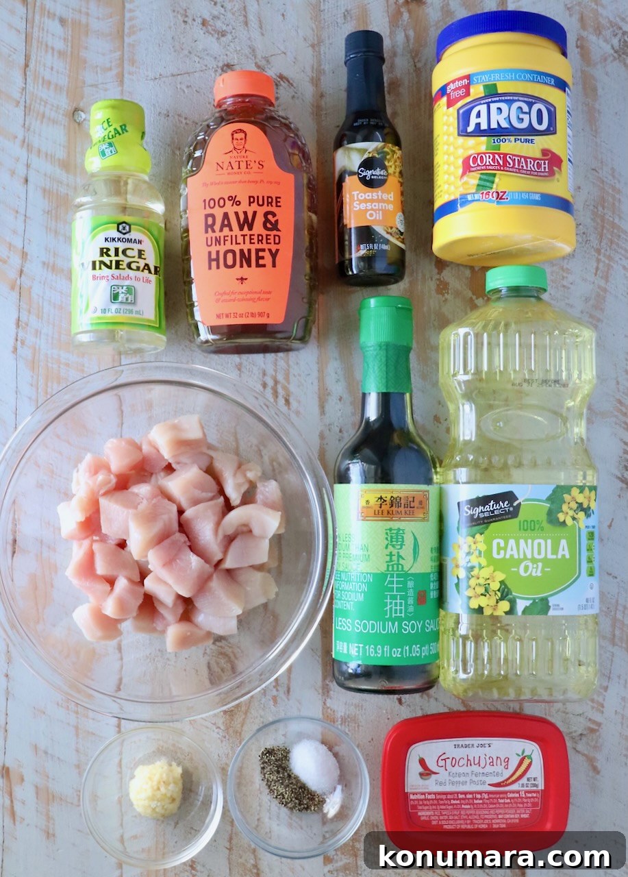 Korean Gochujang Chicken Recipe 3 Ingredients for Gochujang Chicken laid out on a board