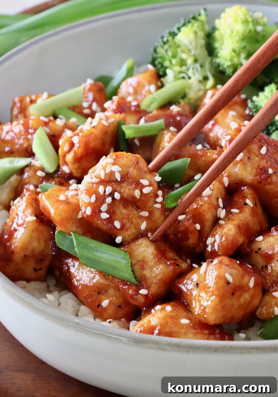 Korean Gochujang Chicken Recipe 8 Gochujang Chicken served with broccoli and chopsticks