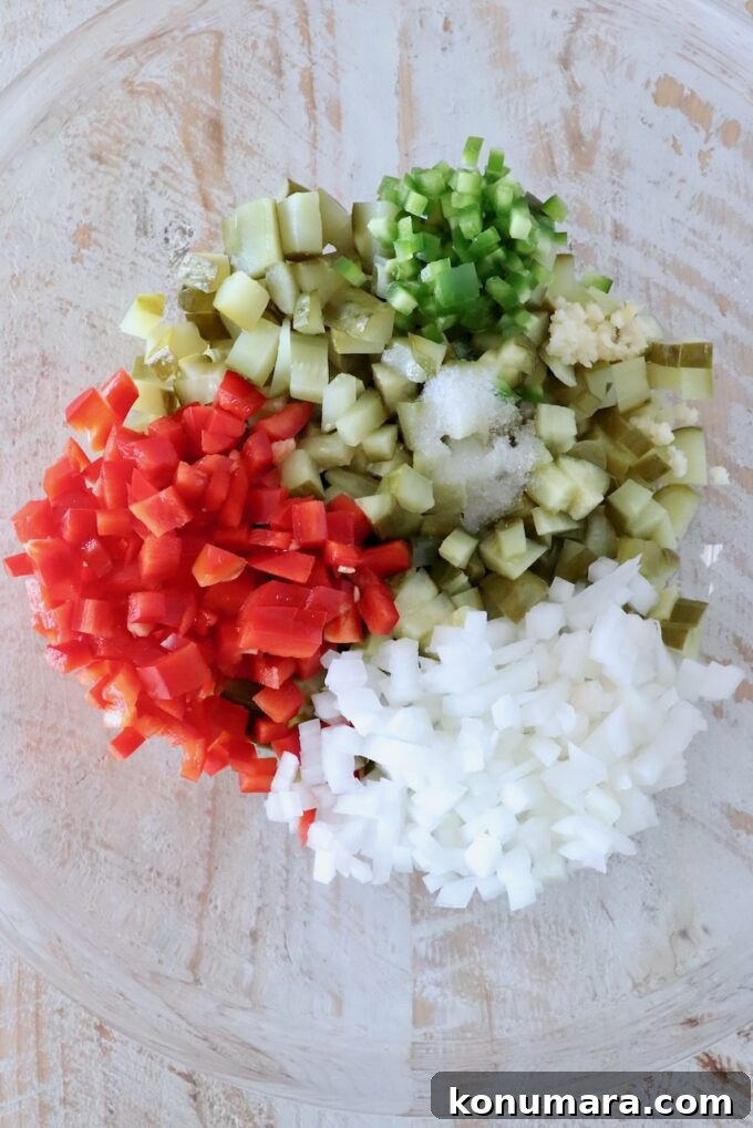 diced pickles, onions and peppers separated in a glass bowl