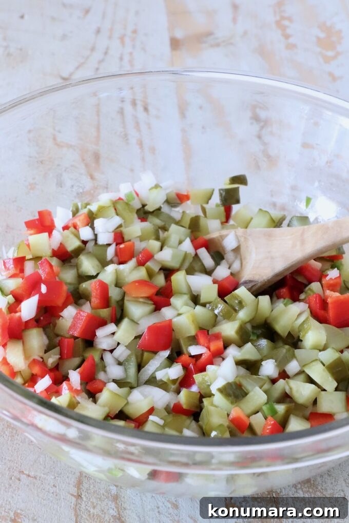 pickle de gallo mixed together in a glass bowl with a spoon