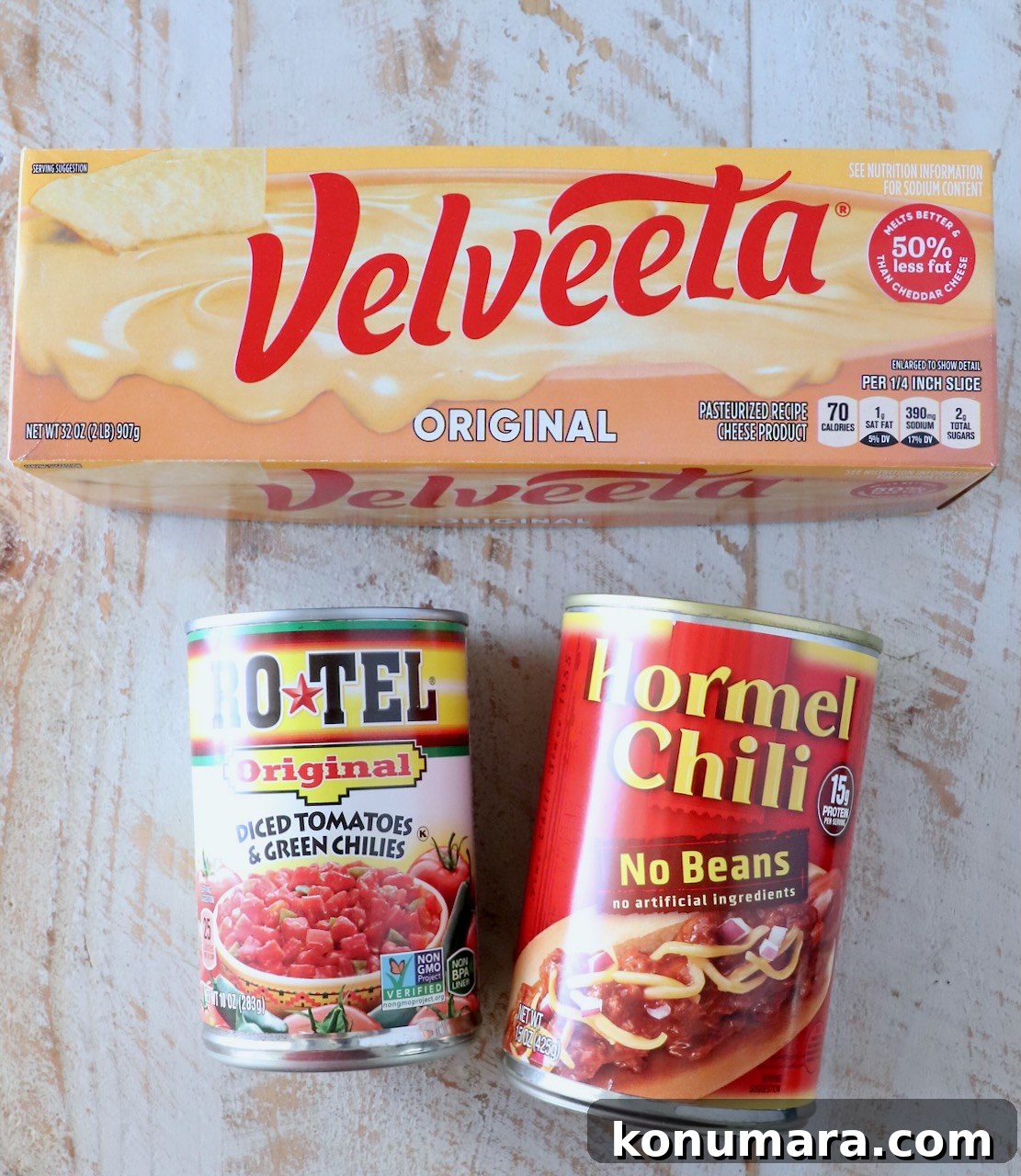 Creamy Chili Cheese Dip Recipe for Game Day 3 ingredients for chili cheese dip on a white wood board