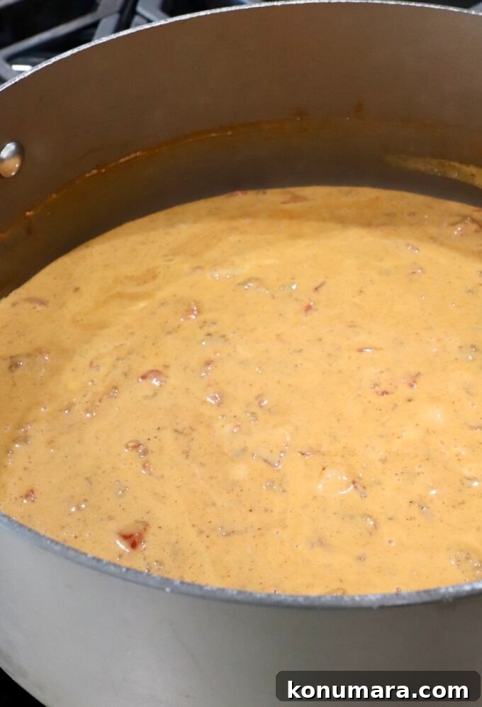 Creamy Chili Cheese Dip Recipe for Game Day 5 chili cheese dip in a large pot on the stove