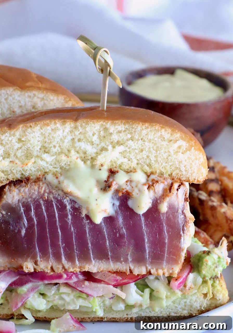 blackened ahi sandwich cut in half on a plate