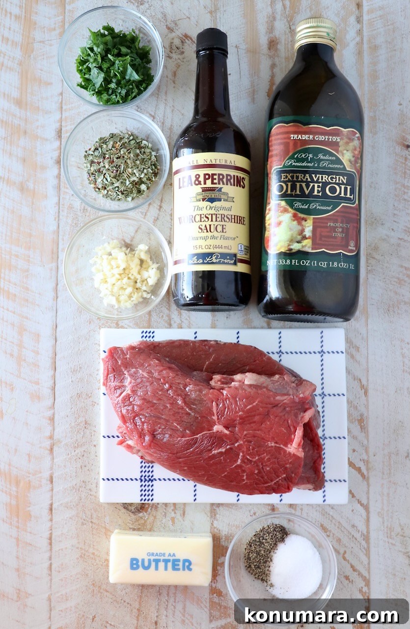 Garlic Butter Steak Bites Recipe: Juicy Pan-Seared Bites 3 ingredients for garlic butter steak bites on a white wood board