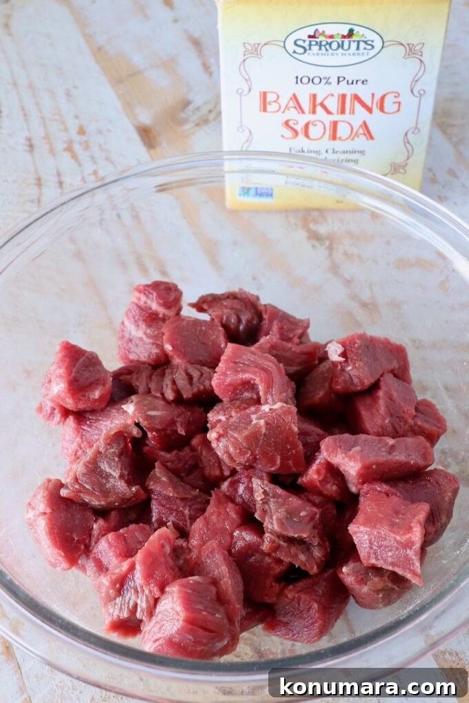 Garlic Butter Steak Bites Recipe: Juicy Pan-Seared Bites 4 cubes of sirloin steak in a glass bowl with a box of baking soda behind it