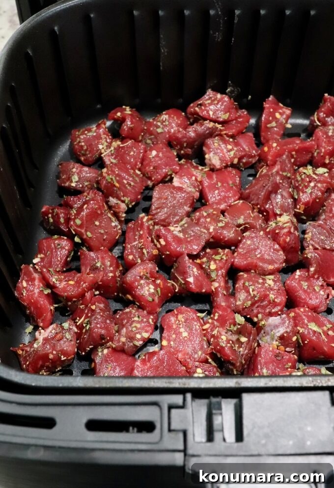 Garlic Butter Steak Bites Recipe: Juicy Pan-Seared Bites 6 seasoned cubes of steak in an air fryer basket