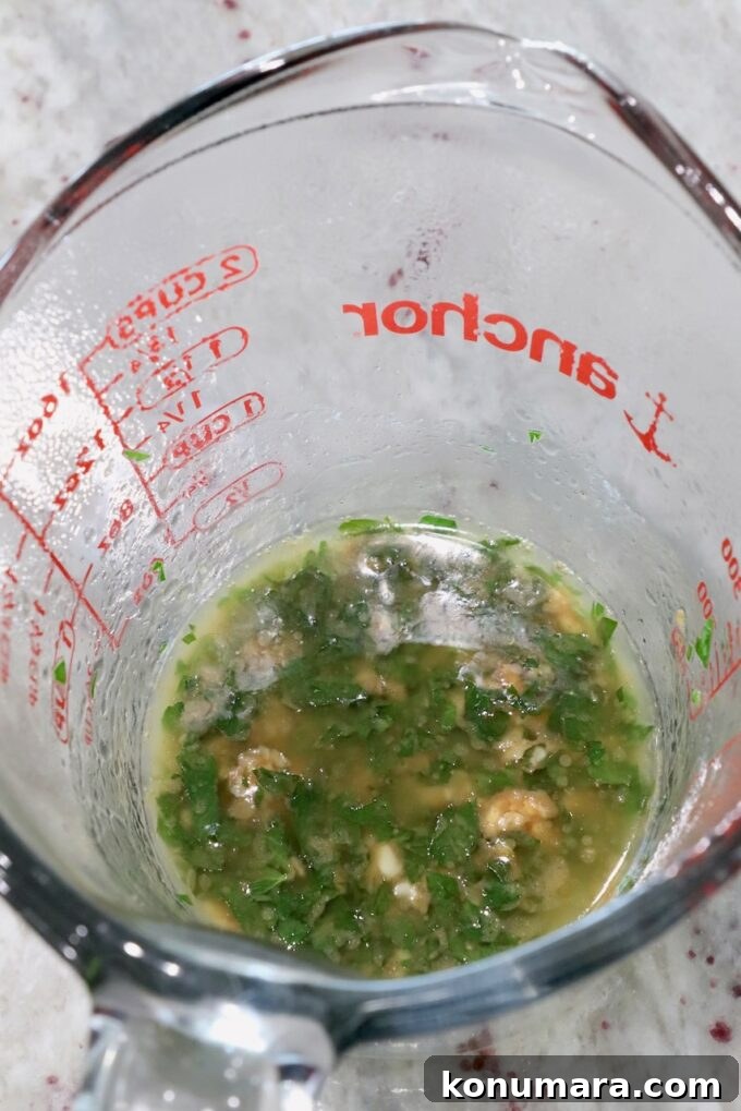 Garlic Butter Steak Bites Recipe: Juicy Pan-Seared Bites 7 garlic, parsley, and melted butter in a glass measuring cup