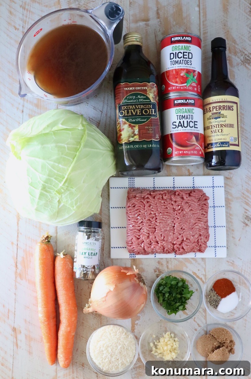 Hearty Cabbage Roll Soup with Savory Tomato Broth 3 ingredients for cabbage roll soup on a white wood board