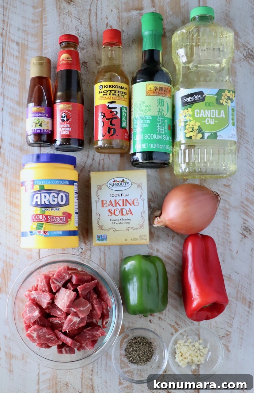 Pepper Steak Stir-Fry Recipe with Bell Peppers 3 ingredients for pepper steak on a white wood board