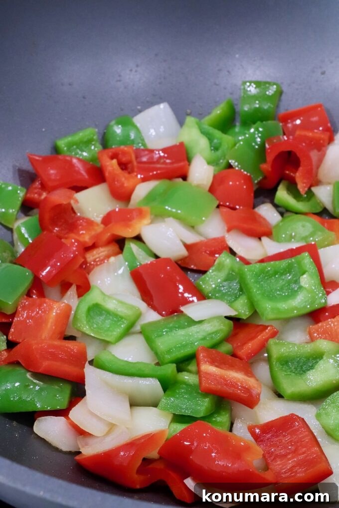 Pepper Steak Stir-Fry Recipe with Bell Peppers 6 cooked diced bell peppers and onions in a large wok