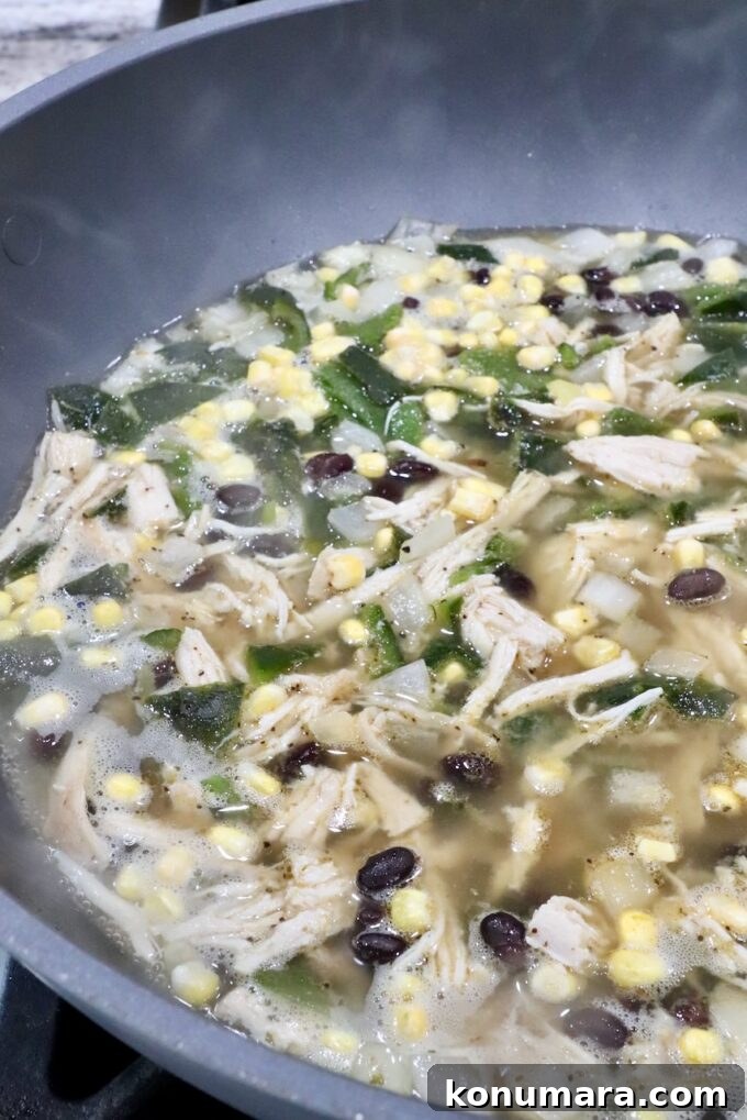 chicken poblano soup in a large pot on the stove
