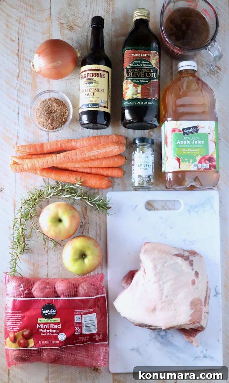ingredients for pork roast on a white wood board
