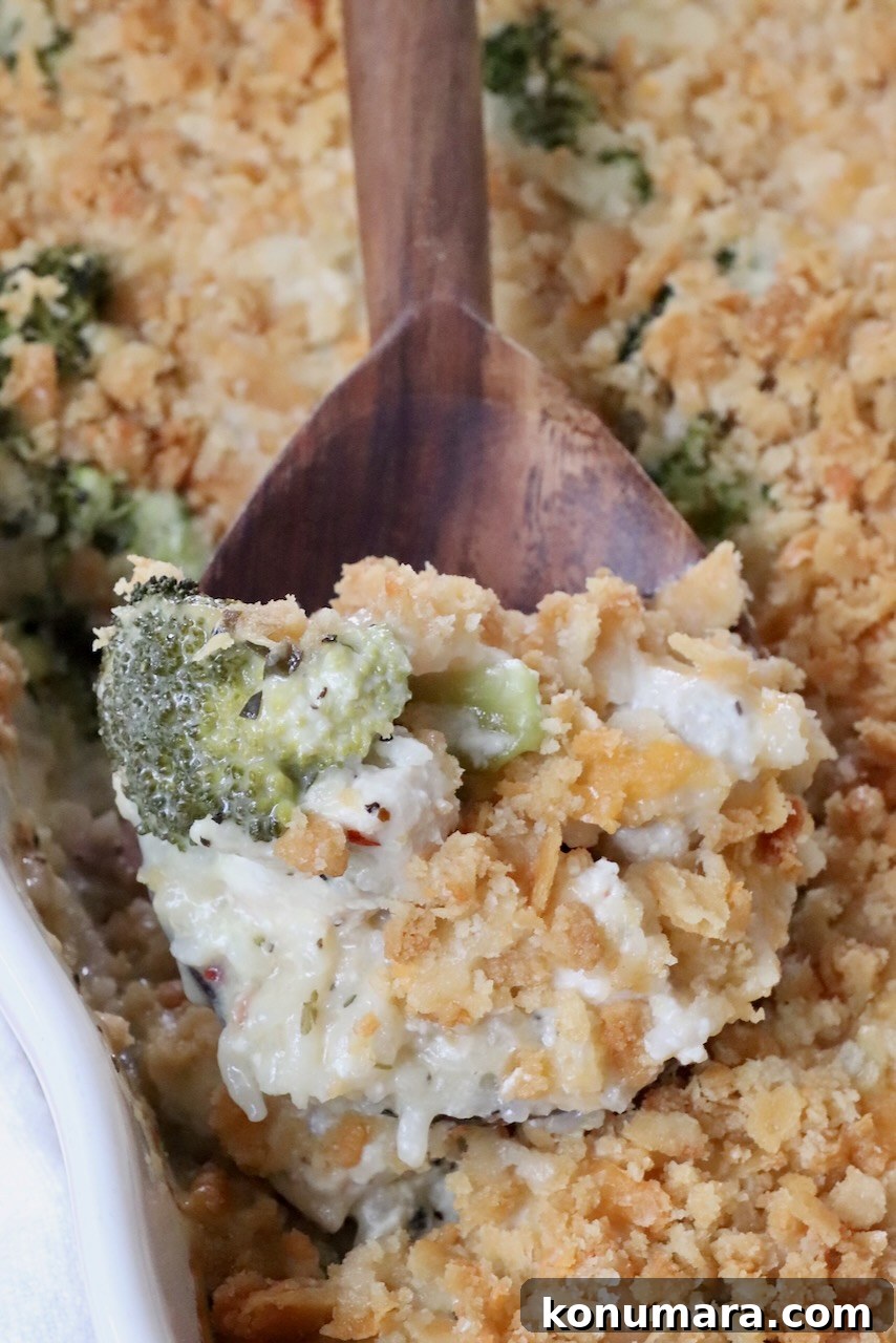 baked chicken broccoli rice casserole in a dish with a serving spoon
