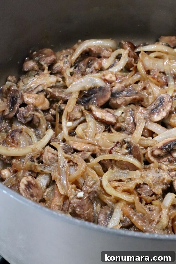 How to Make Chopped Steak with Mushroom Gravy 11 sliced onions and mushrooms combined with flour and butter in a large pot