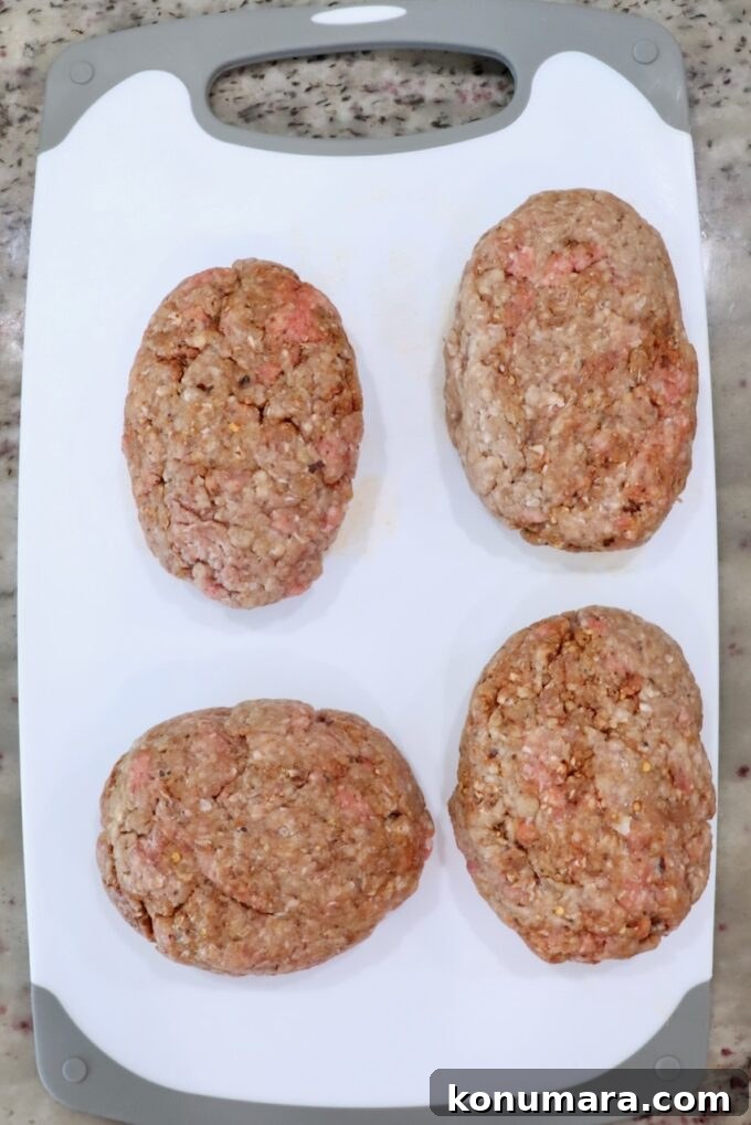 How to Make Chopped Steak with Mushroom Gravy 4 seasoned ground beef patties on a white cutting board