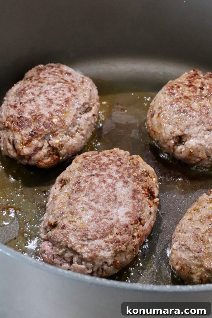 How to Make Chopped Steak with Mushroom Gravy 6 seared ground beef patties in a large dutch oven on the stove