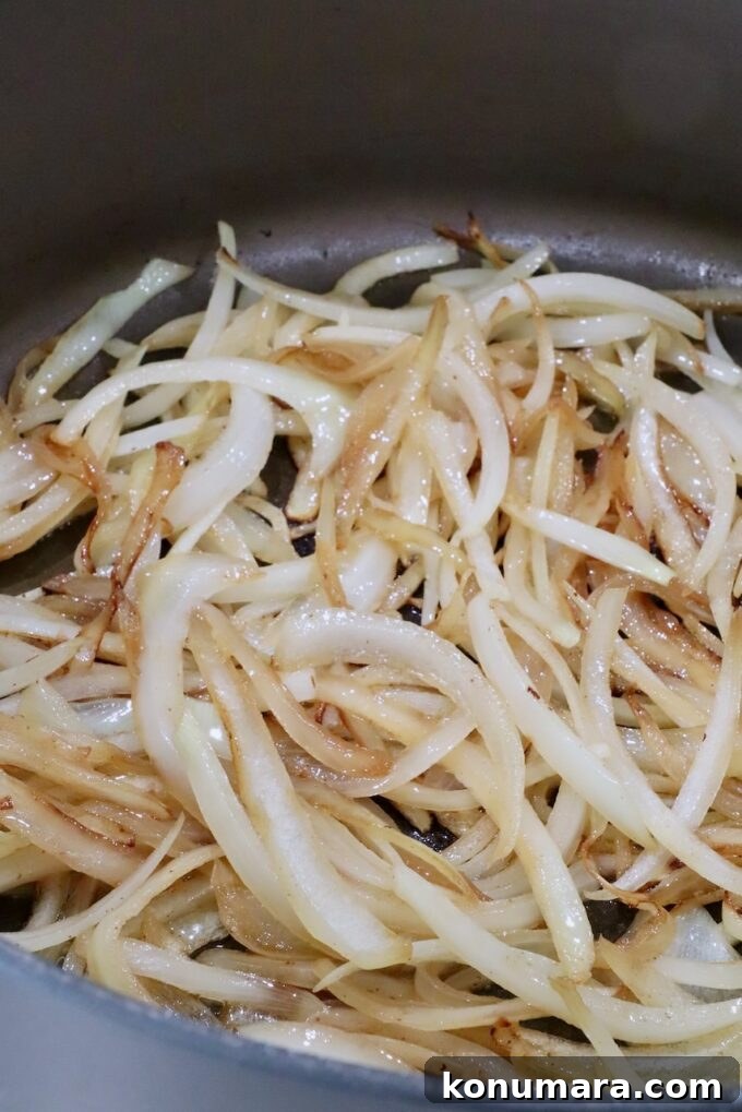 How to Make Chopped Steak with Mushroom Gravy 7 sliced onions cooking in a large pot