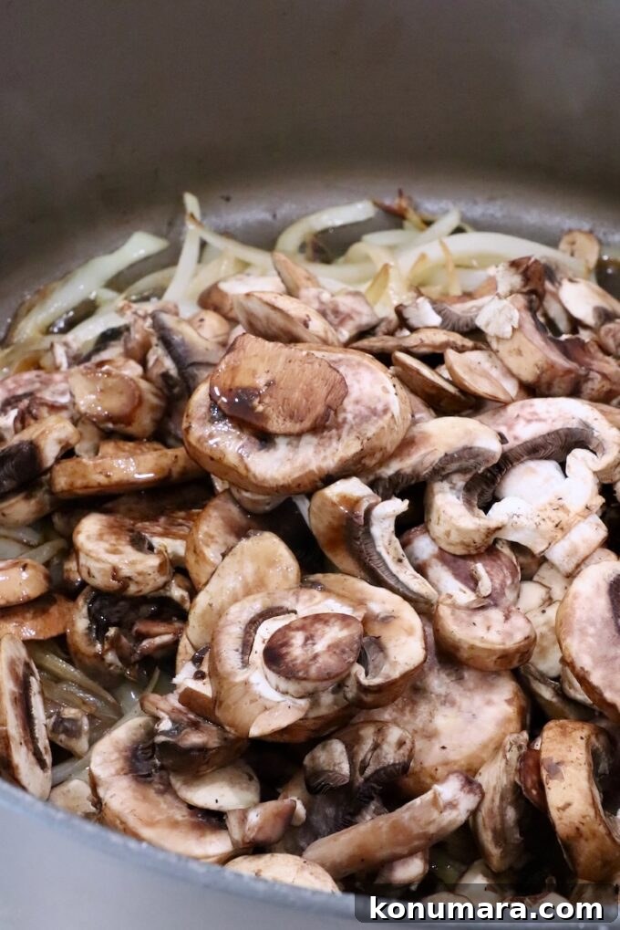 How to Make Chopped Steak with Mushroom Gravy 8 sliced onions and sliced mushrooms in a large pot