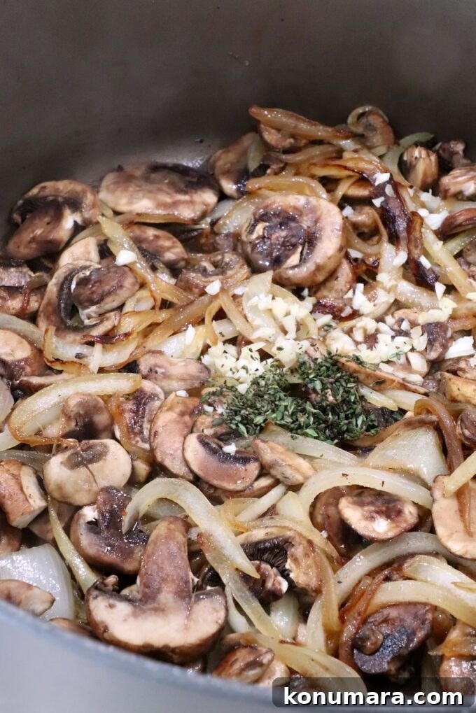 How to Make Chopped Steak with Mushroom Gravy 9 seasoned sliced onions and mushrooms in a pot