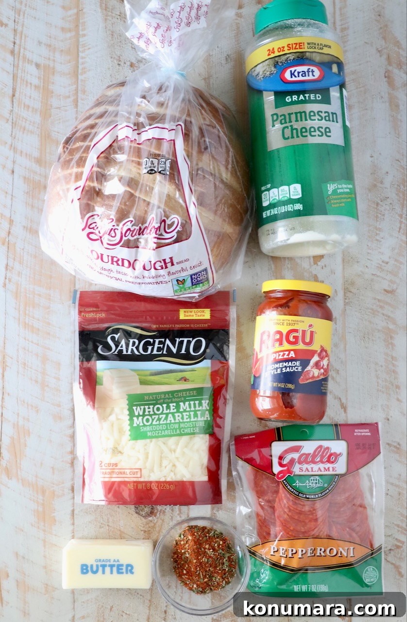 Pepperoni Pizza Grilled Cheese Recipe 3 ingredients for pizza grilled cheese on a white wood board