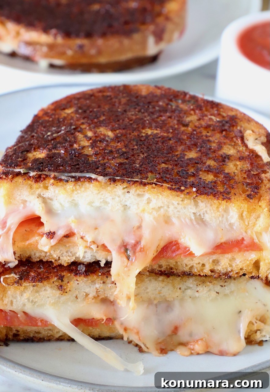 Pepperoni Pizza Grilled Cheese Recipe 10 pizza grilled cheese cut in half and stacked up on a plate