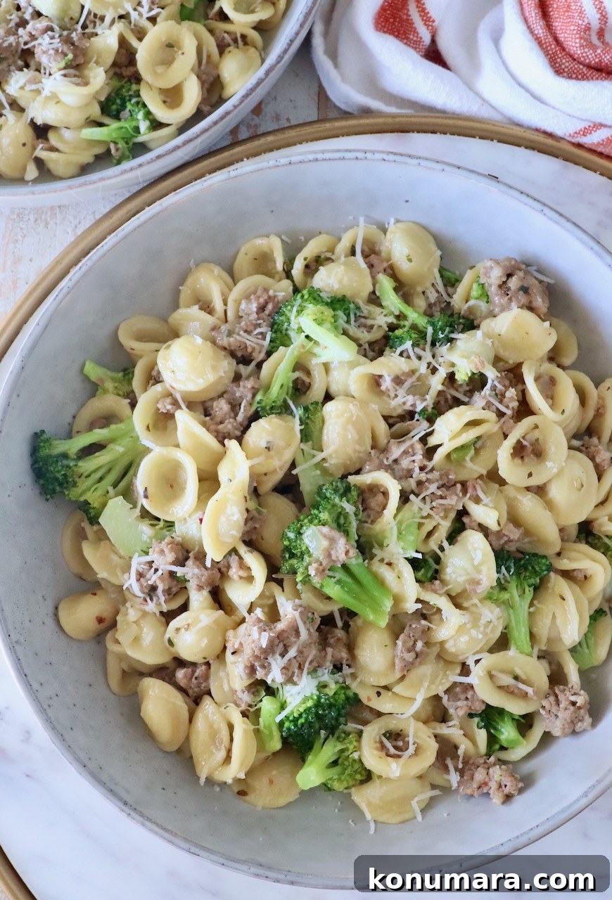 cooked orecchiette pasta with broccoli and Italian sausage in a bowl