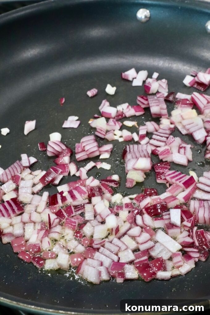 diced red onions in a skillet