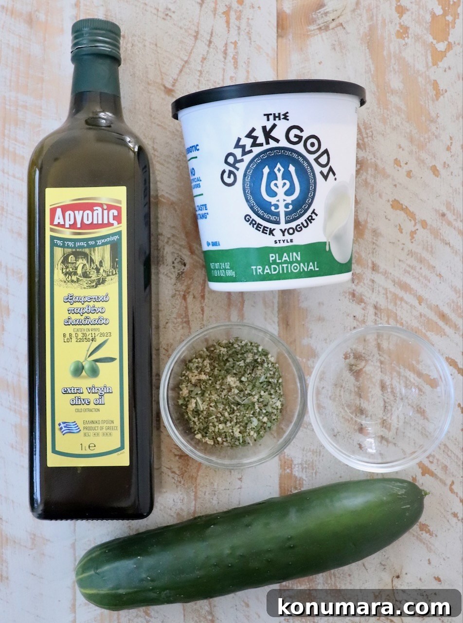 ingredients for tzatziki sauce on a white wood board
