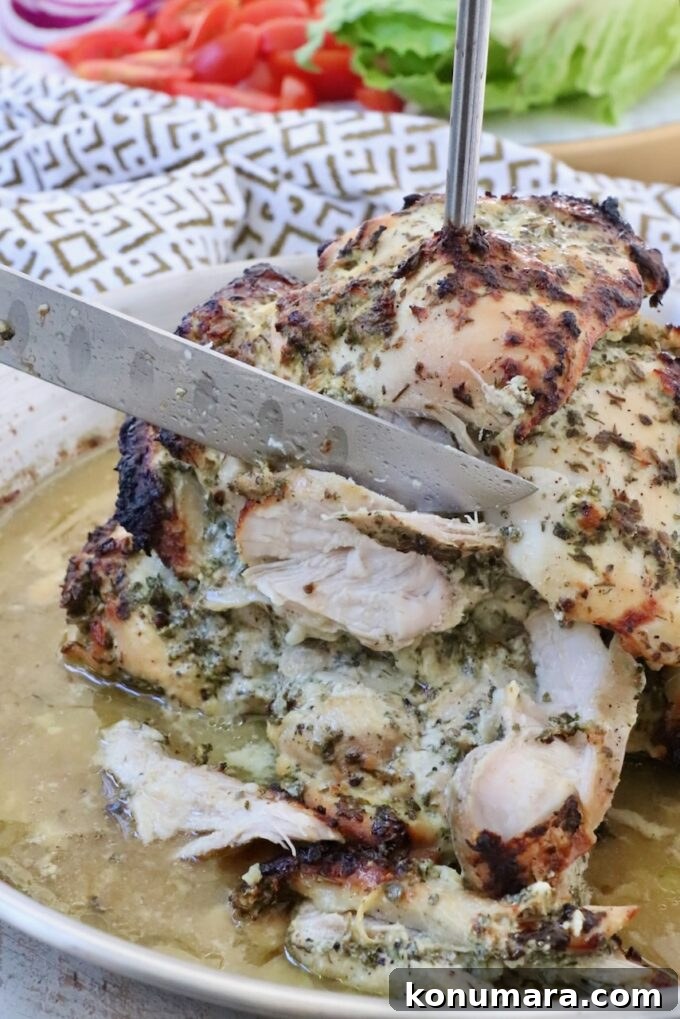 Homemade Greek Chicken Gyros Recipe 7 chicken sliced from a rotisserie with a large knife