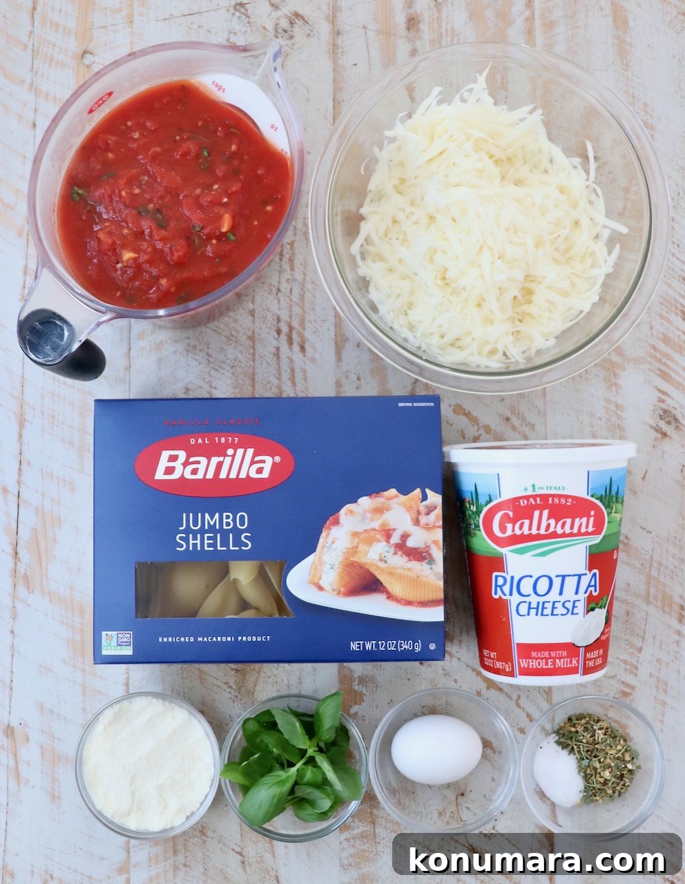 Ricotta Stuffed Shells Recipe with Spinach 3 ingredients for stuffed shells on a white wood board