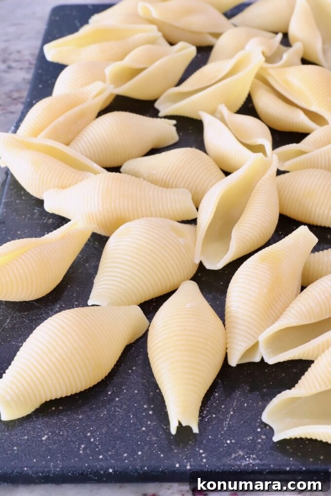 Ricotta Stuffed Shells Recipe with Spinach 4 cooked jumbo pasta shells on a cutting board