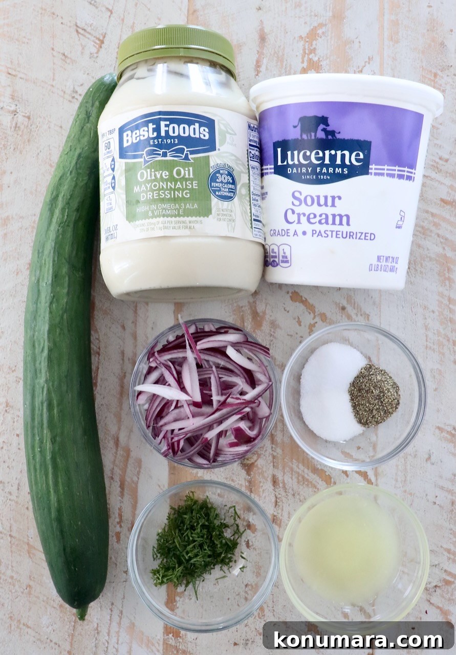 Creamy Cucumber Salad with Dill and Yogurt Dressing 3 ingredients for creamy cucumber salad on a white wood board