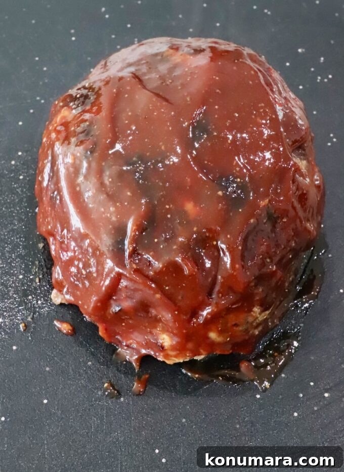 30-Minute Air Fryer Meatloaf Recipe with Crispy Edges 9 cooked, glazed meatloaf on a cutting board