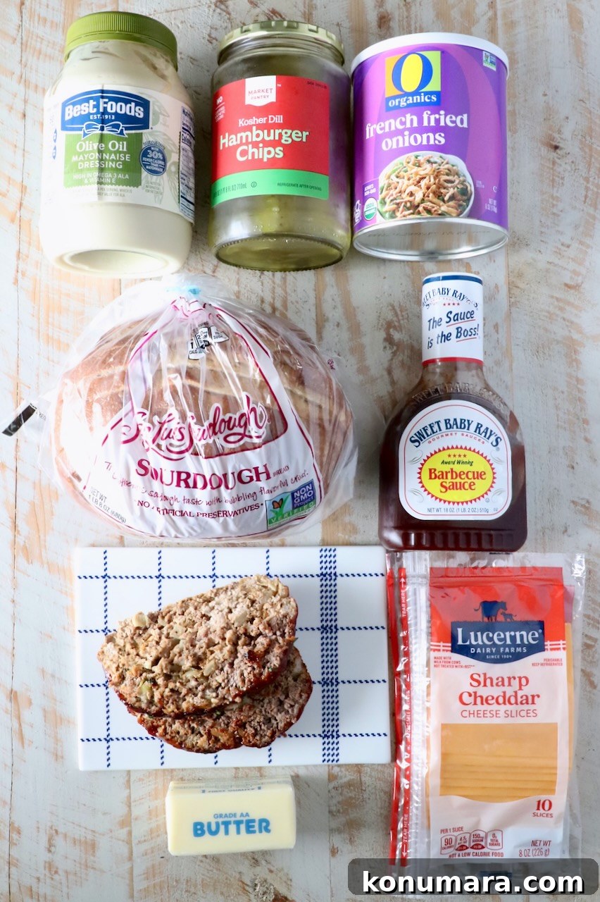 How to Make a Classic Meatloaf Sandwich 3 ingredients for meatloaf sandwich on a white wood board