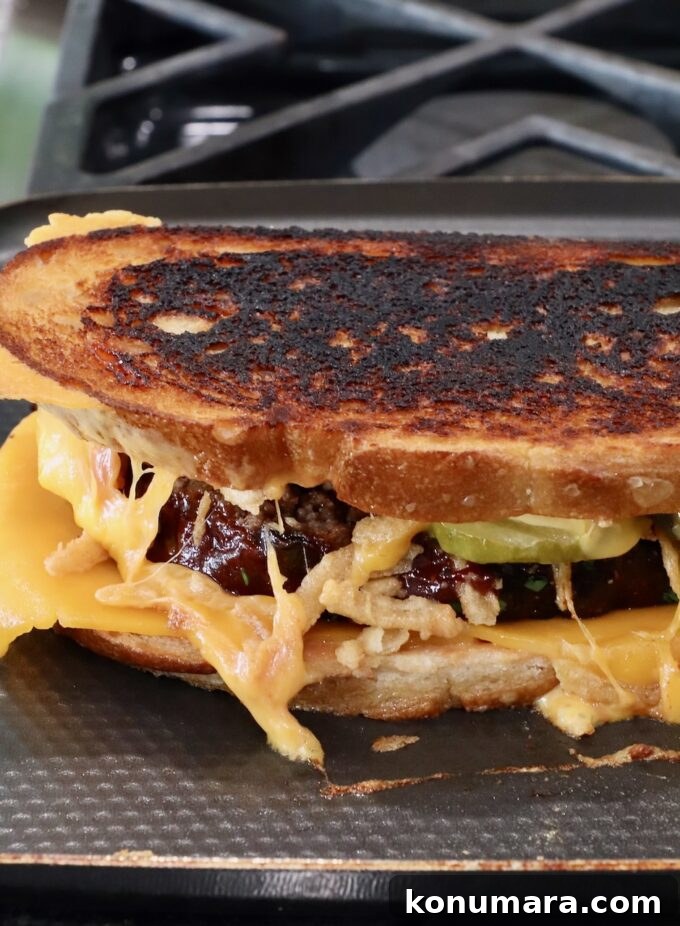 How to Make a Classic Meatloaf Sandwich 9 cooked meatloaf sandwich on a griddle pan on the stove