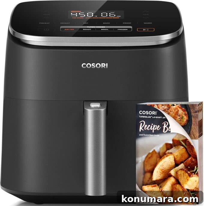 cosori turboblaze 6 quart air fryer with a recipe book in front of the air fryer