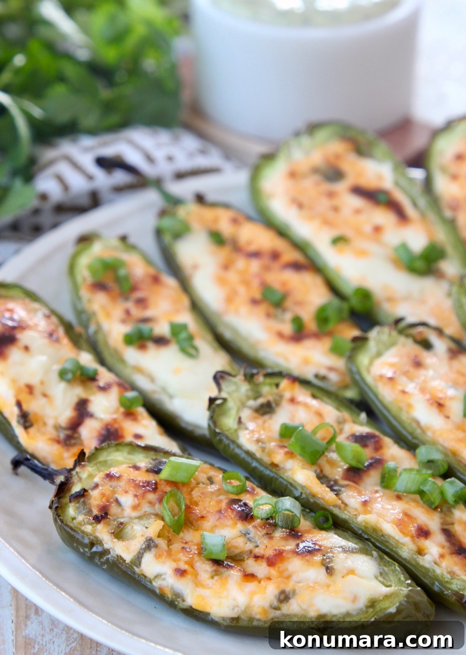 Smoky Grilled Jalapeno Poppers Recipe with Cream Cheese 2 cheese stuffed grilled jalapenos on plate