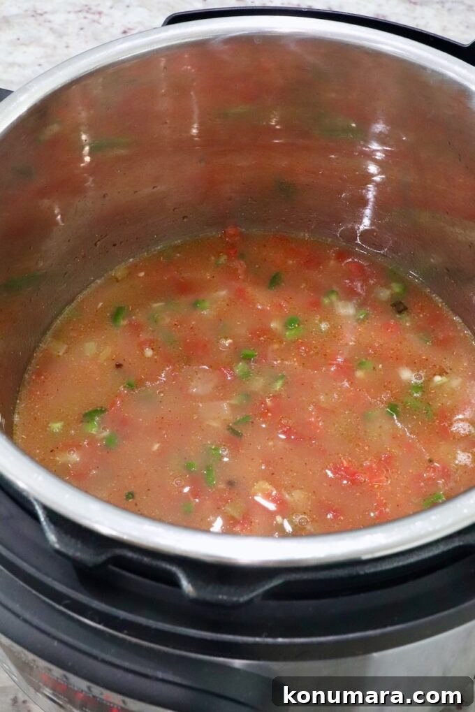 diced vegetables and seasoned broth in an Instant Pot