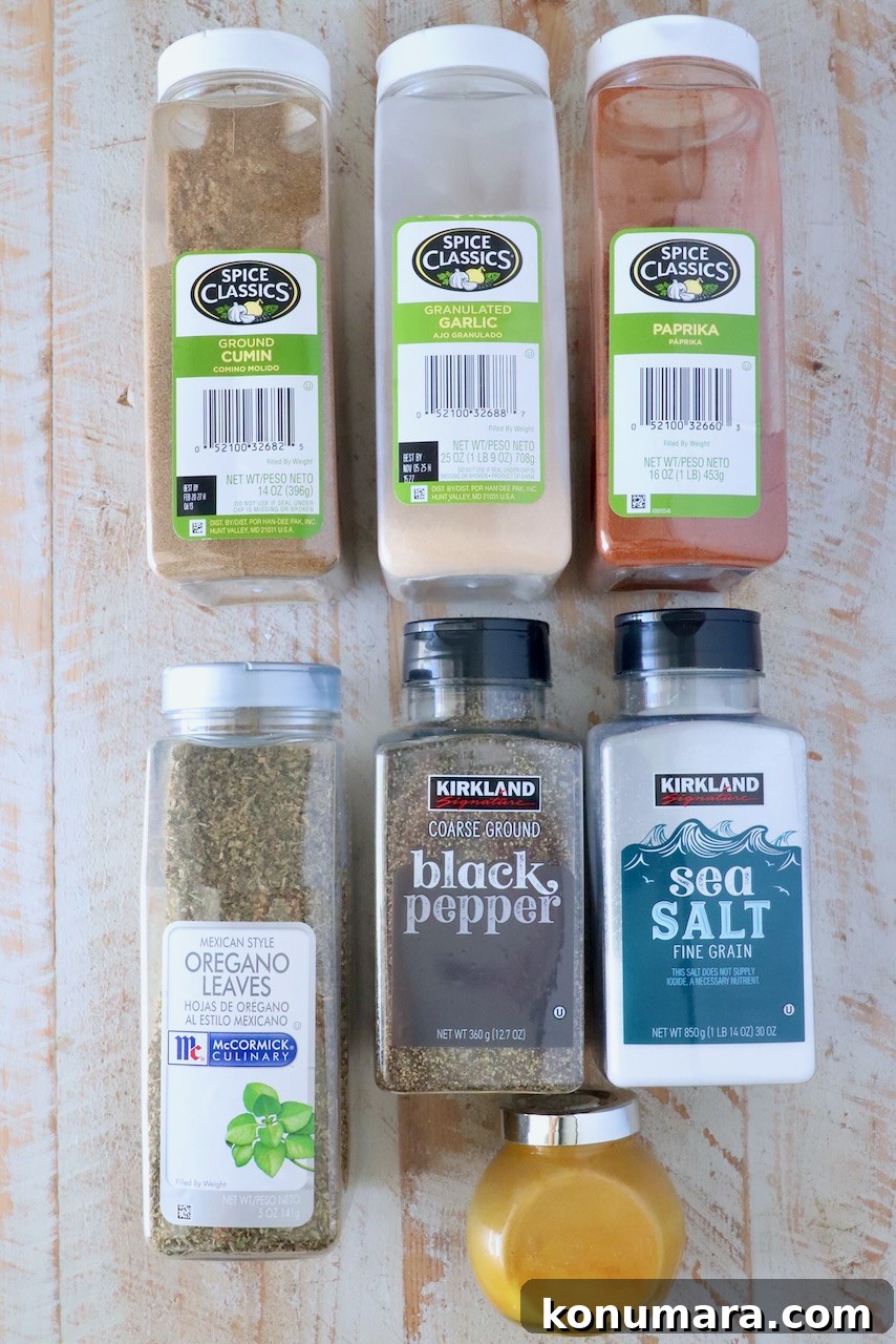 Homemade Adobo Seasoning Mix for Authentic Flavor 3 containers of spices lined up on a white wood board
