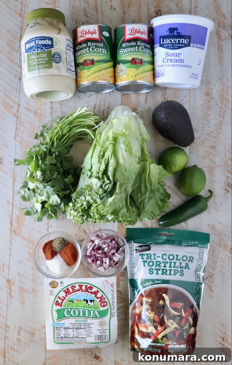 ingredients for Mexican street corn salad on a white wood board