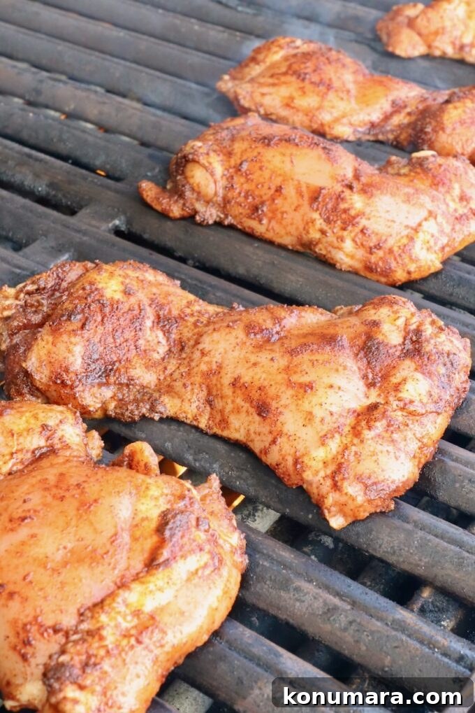 Chipotle Honey Glazed Chicken Recipe 9 Raw seasoned chicken thighs being placed on a grill