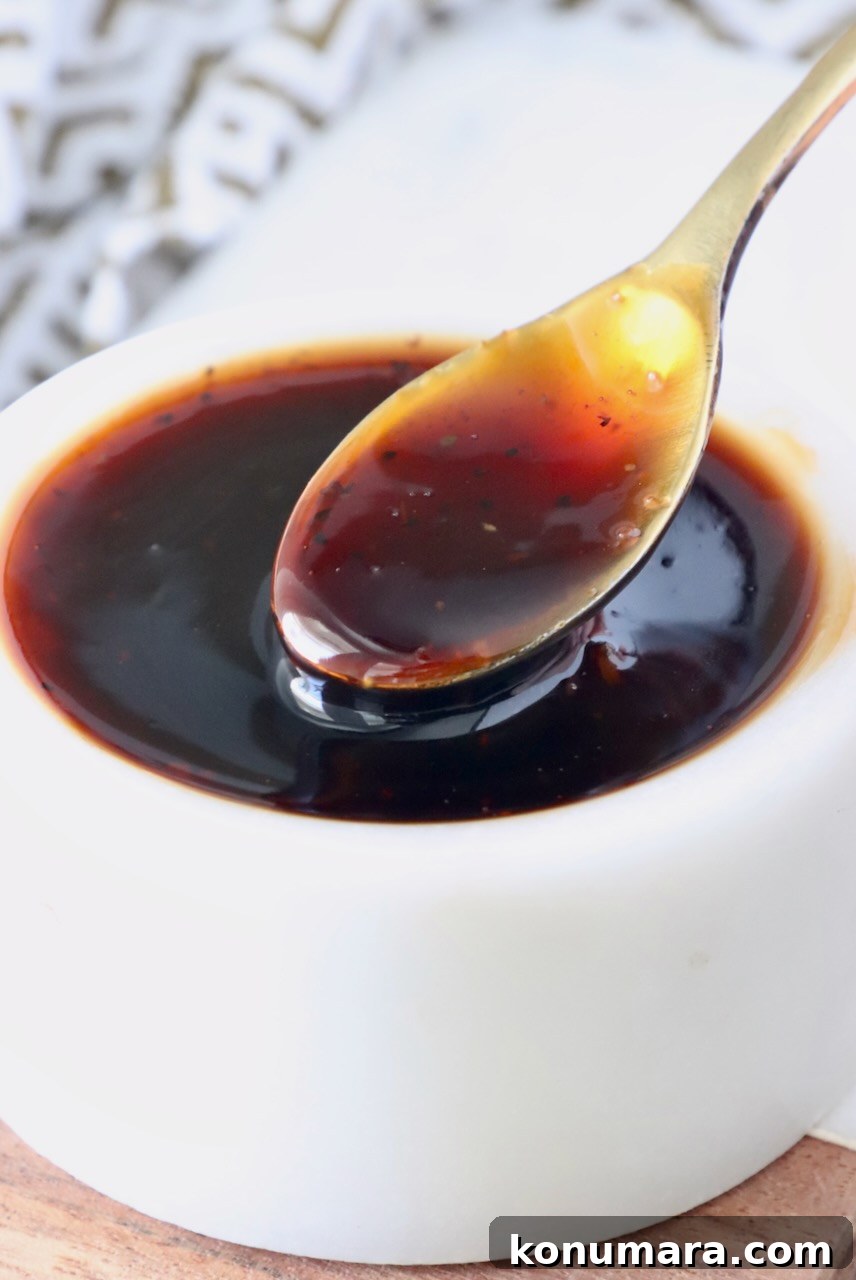 Authentic Korean BBQ Sauce for Bulgogi and Galbi 7 korean bbq sauce in a small bowl with a small spoon dipped in the sauce