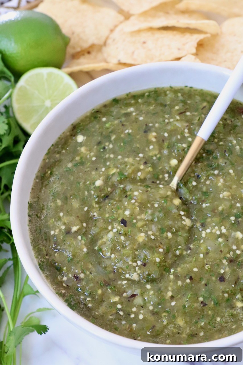 tomatillo salsa verde in a bowl with a spoon