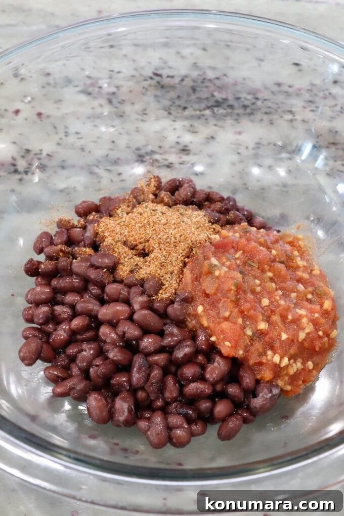Smoky Black Bean Tacos with Avocado Lime Crema 4 canned black beans, salsa and taco seasoning in a glass bowl