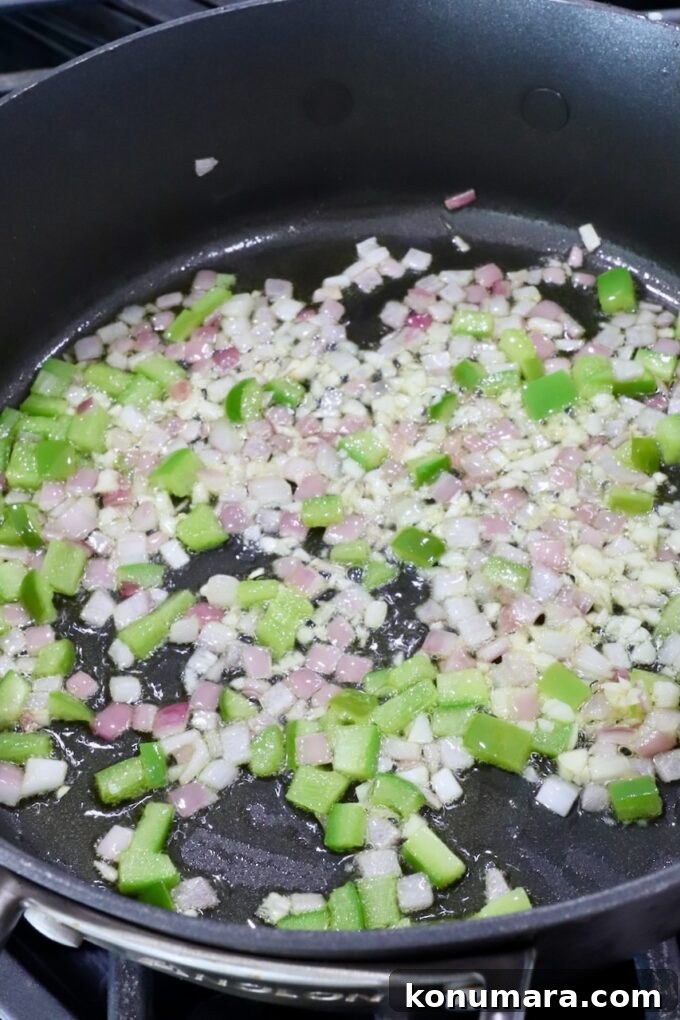 diced onion and bell pepper in a skillet on the stove